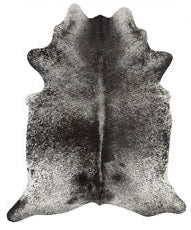 Black and white cowhide rug on a white background